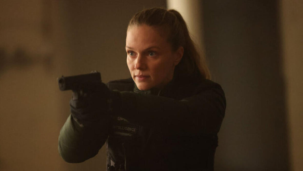  Tracy Spiridakos as Hailey Upton holding a gun in the Season 11 finale of Chicago P.D. 