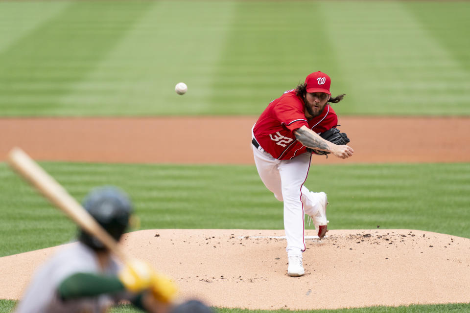Washington Nationals starting pitcher Trevor Williams, right, delivers during the first inning of a baseball game against the Oakland Athletics, Sunday, Aug. 13, 2023, in Washington. (AP Photo/Stephanie Scarbrough)