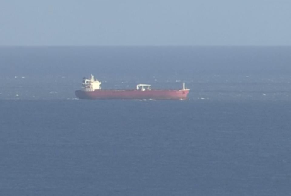 In this image taken from SKY video, shows a tanker at sea, as filmed from land on Sunday Oct. 25, 2020. British police are investigating an undisclosed incident aboard an oil tanker in the English Channel. The incident reportedly took place aboard the Libyan-registered oil tanker Nave Andromeda south of Sandown on Isle of Wight, according to Isle of Wight Radio. (SKY News via AP)