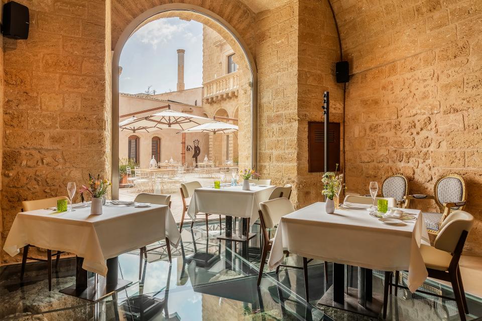 Il Tempo Nuovo restaurant—with glass floors looking to the remains of the Norman tower underneath—at Castello di Ugento.