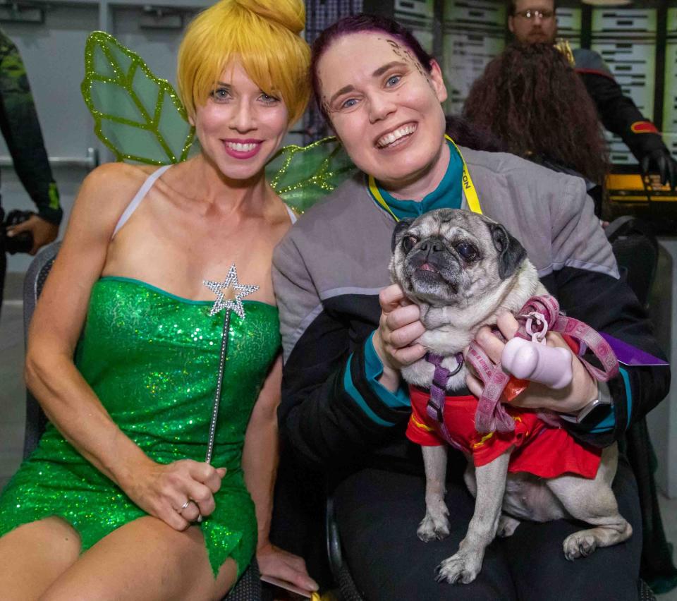 (l-r) Port St. Lucie resident Liz Petrell, dressed as Tinker Bell, and Kristal Mize, dressed as Jadzia Dax from Star Trek, pose for a photo with MizeÕs dog Lilo, during the Ultracon Comic Con event at the South Florida Fairgrounds Expo Center Saturday August 26, 2023. 