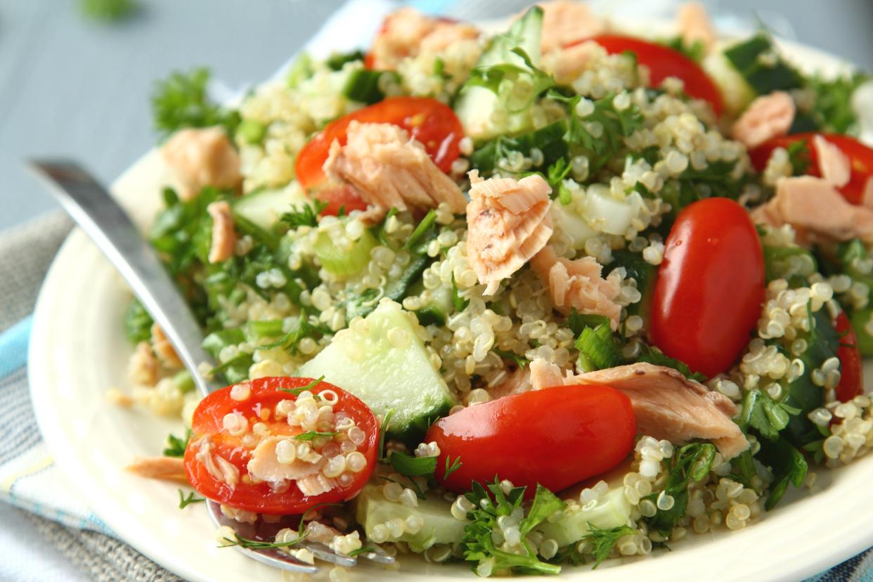 Tabbouleh salad with quinoa, salmon, tomatoes, cucumbers and parsley