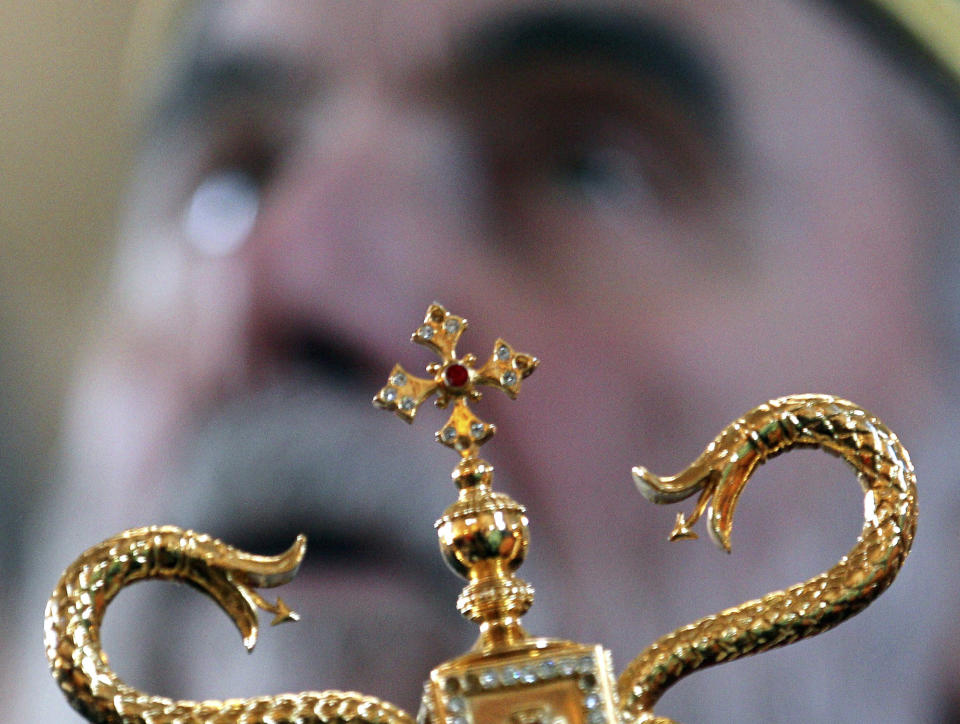 FILE - In this Jan. 6, 2011, file photo Patriarch Irinej performs the liturgy on the Orthodox Christmas Eve in St. Simeon Serbian Orthodox church in Belgrade, Serbia. Serbia's Orthodox Church said Friday, Nov. 20, 2020, the leader, Patriarch Irinej, has died after testing positive for the coronavirus. He was 90. (AP Photo/Darko Vojinovic, File)