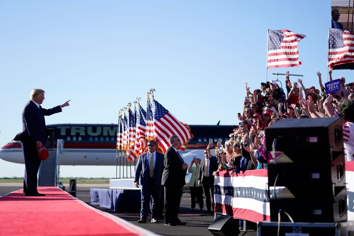 Former President Donald Trump points to supporters as he arrives to speak at a campaign rally at Waco Regional Airport, Saturday, March 25, 2023 (AP)