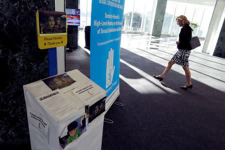 A woman walks near a box for donations to Syrian refugees during the 72nd United Nations General Assembly at U.N. headquarters in New York, U.S., September 23, 2017. REUTERS/Eduardo Munoz
