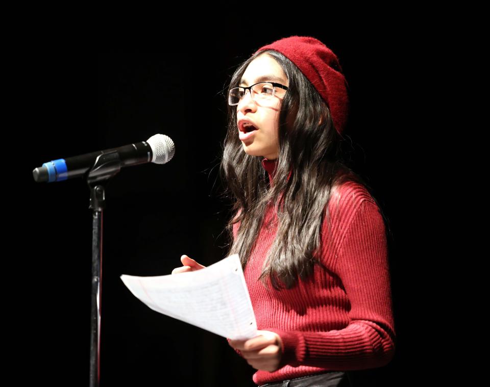 Montserrat Ruiz reads poetry that she wrote during Open Mic Night hosted by the Jam Club at Brockton High School in Brockton, Massachusetts on Friday, March 4, 2022.