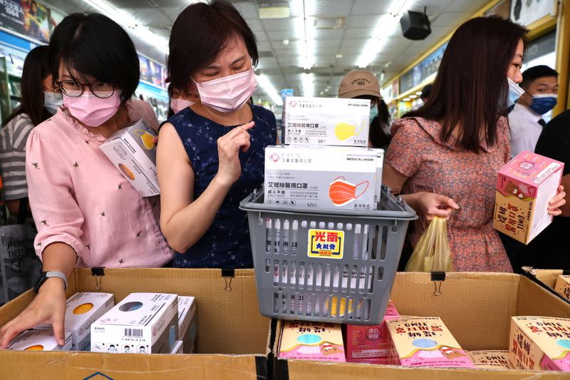 People buy boxes of protective face masks following the outbreak of coronavirus disease (COVID-19), in Taipei,