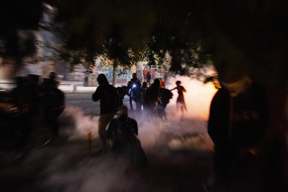 Twice on July Fourth, police declared a riot in downtown Portland, Ore., July 4, 2020. Portland police say more than 12 people were arrested early Sunday after throwing fireworks and mortars as they clashed with police during the latest rally decrying police brutality. (Beth Nakamura/The Oregonian via AP)