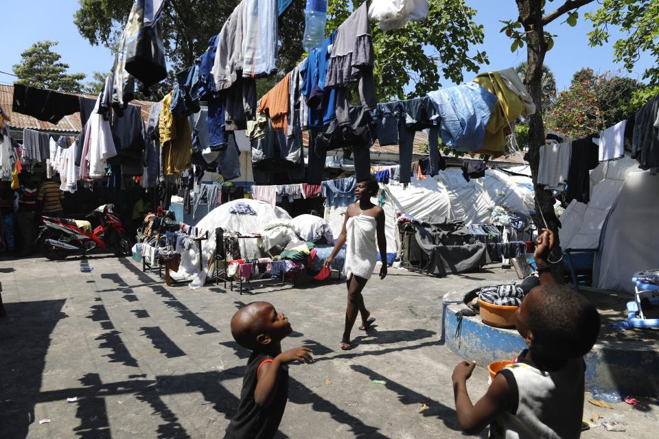 Children play in the courtyard of a shelter for families displaced by gang violence, in Port-au-Prince, Haiti, Thursday, March 14, 2024. (AP Photo/Odelyn Joseph)