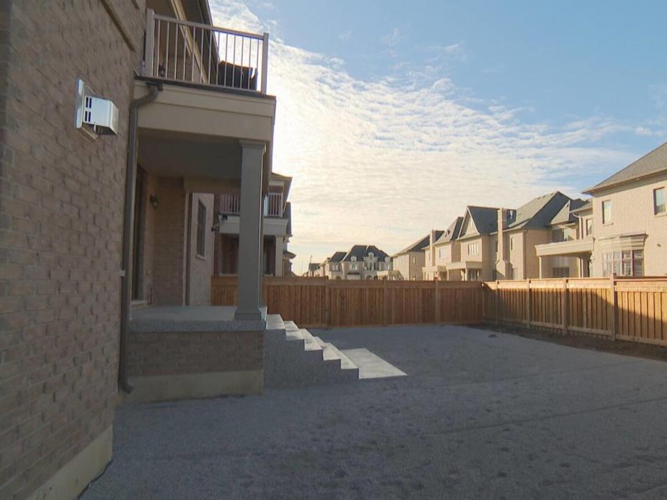 Polyviou hired Freedom Pools to lay interlocked patio stones, install a set of concrete stairs and build a wooden canopy in the backyard.  (Mark Boschler/CBC - image credit)