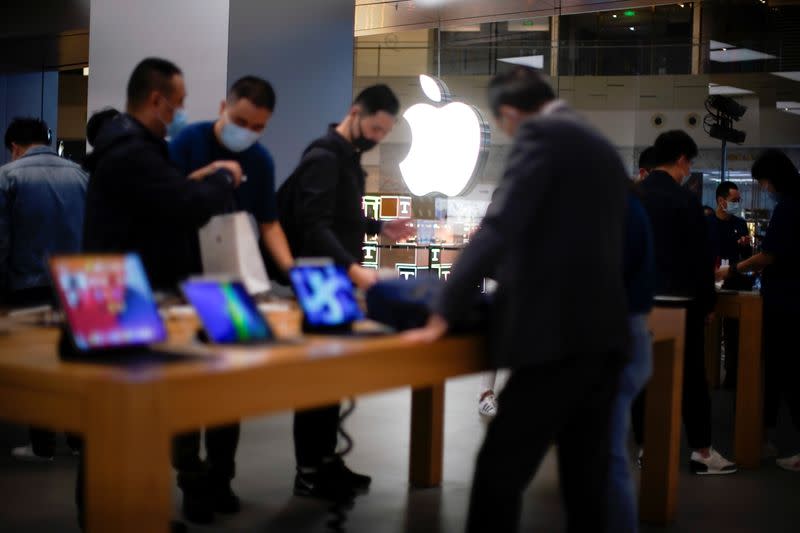 People look at Apple products at an Apple Store, as the coronavirus disease (COVID-19) outbreak continues in Shanghai