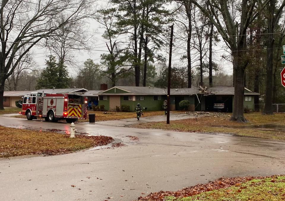 A fallen tree limb damages a house during a rainy Thursday, Jan. 25, 2024 in Jackson, Miss.