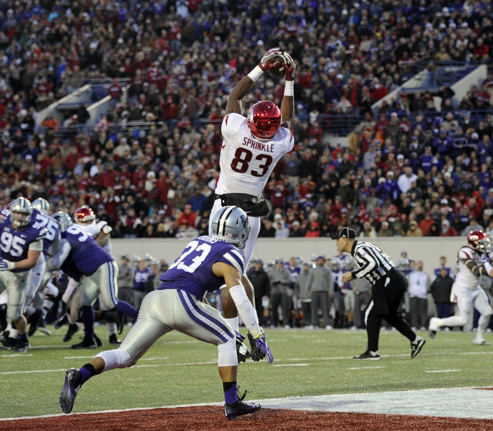 Jan 2, 2016; Memphis, TN, USA; Arkansas Razorbacks tight end Jeremy Sprinkle (83) catches a touchdown against <a class="link " href="https://sports.yahoo.com/ncaaf/teams/kansas-st/" data-i13n="sec:content-canvas;subsec:anchor_text;elm:context_link" data-ylk="slk:Kansas State Wildcats;sec:content-canvas;subsec:anchor_text;elm:context_link;itc:0">Kansas State Wildcats</a> defensive back Morgan Burns (33) during the second half at Liberty Bowl. Arkansas Razorbacks defeated the Kansas State Wildcats 45-23. Mandatory Credit: Justin Ford-USA TODAY Sports