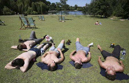 A group of men sunbathe on a sunny day in Regents Park in London, Britain July 19, 2016. REUTERS/Neil Hall