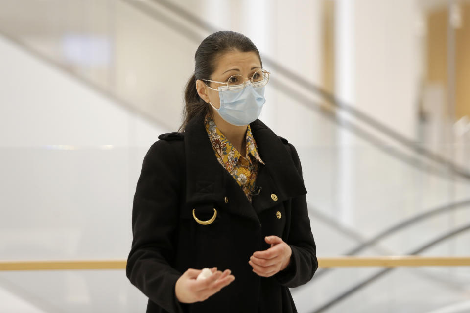 Plaintiff Sabrina Deliry arrives for a hearing at the Paris Palace of Justice, Wednesday, March 3, 2021. A Paris court holds a hearing Wednesday in a class-action effort to hold French health authorities and companies accountable after thousands of people with the virus died in nursing homes, and families were locked out and left in the dark about what was happening to their isolated loved ones. Sabrina Deliry has mobilized families around France since her mother's Paris nursing home was first locked down a year ago. (AP Photo/Lewis Joly)