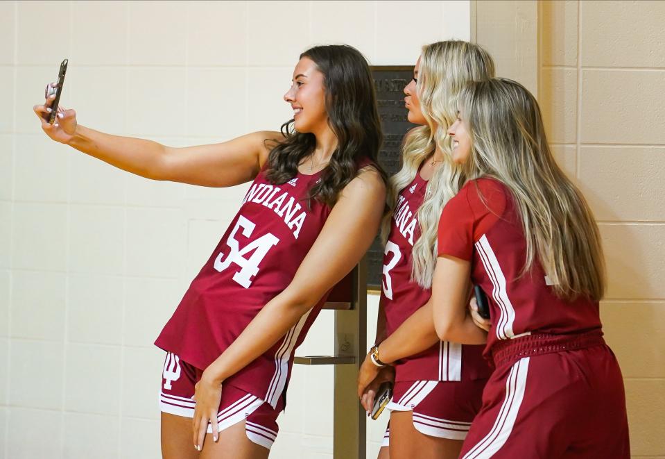 Indiana’s Mackenzie Holmes, Sydney Parrish and Sara Scalia take a photo during the Indiana University basketball media day at Simon Skjodt Assembly Hall on Wednesday, Sept. 20, 2023.
