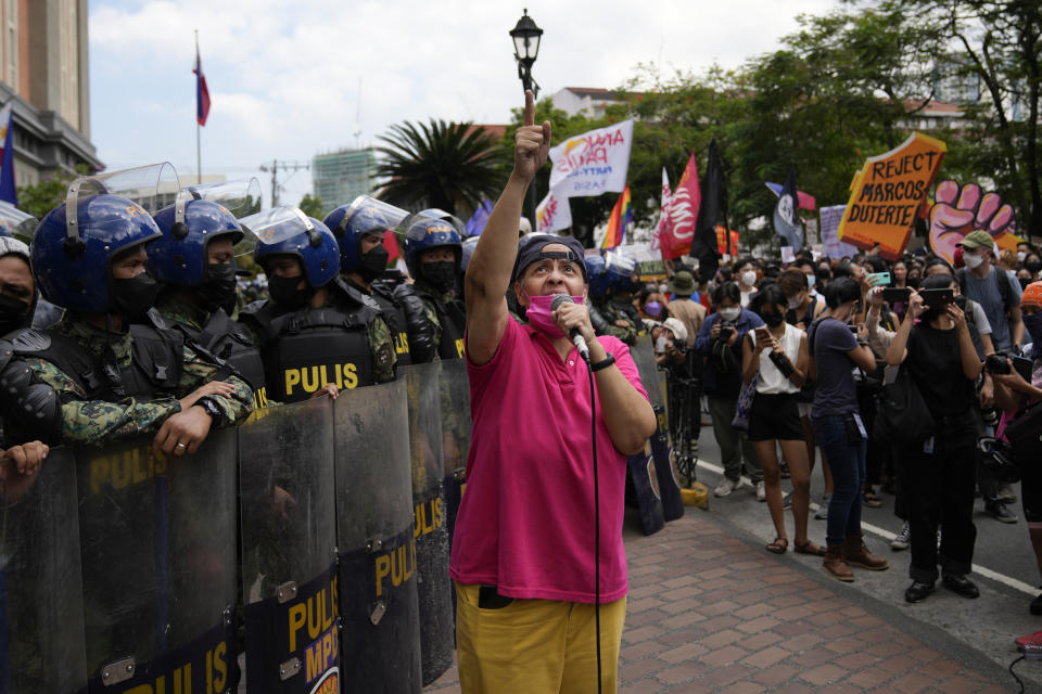 A protester speaks during a rally in front of the office of the Commission on Elections as they question the results of the presidential elections in Manila, Philippines on Tuesday May 10, 2022. The namesake son of late Philippine dictator Ferdinand Marcos appeared to have been elected Philippine president by a landslide in an astonishing reversal of the 1986 "People Power" pro-democracy revolt that booted his father into global infamy. (AP Photo/Aaron Favila)