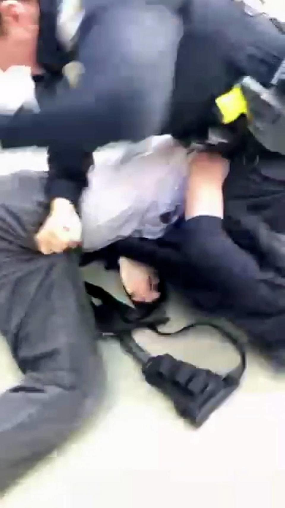 A San Luis Obispo police officer arrests a protester during an pro-Palestine demonstration at Cal Poly on Jan. 23, 2024.