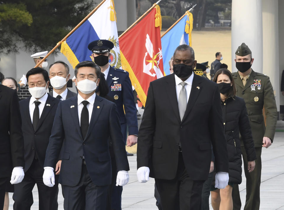 South Korean Defense Minister Suh Wook, center left, and U.S. Defense Secretary Lloyd Austin, center right, walk during their visit to the National Cemetery in Seoul, South Korea, Thursday, March 18, 2021. (Kim Min-hee/Pool Photo via AP)