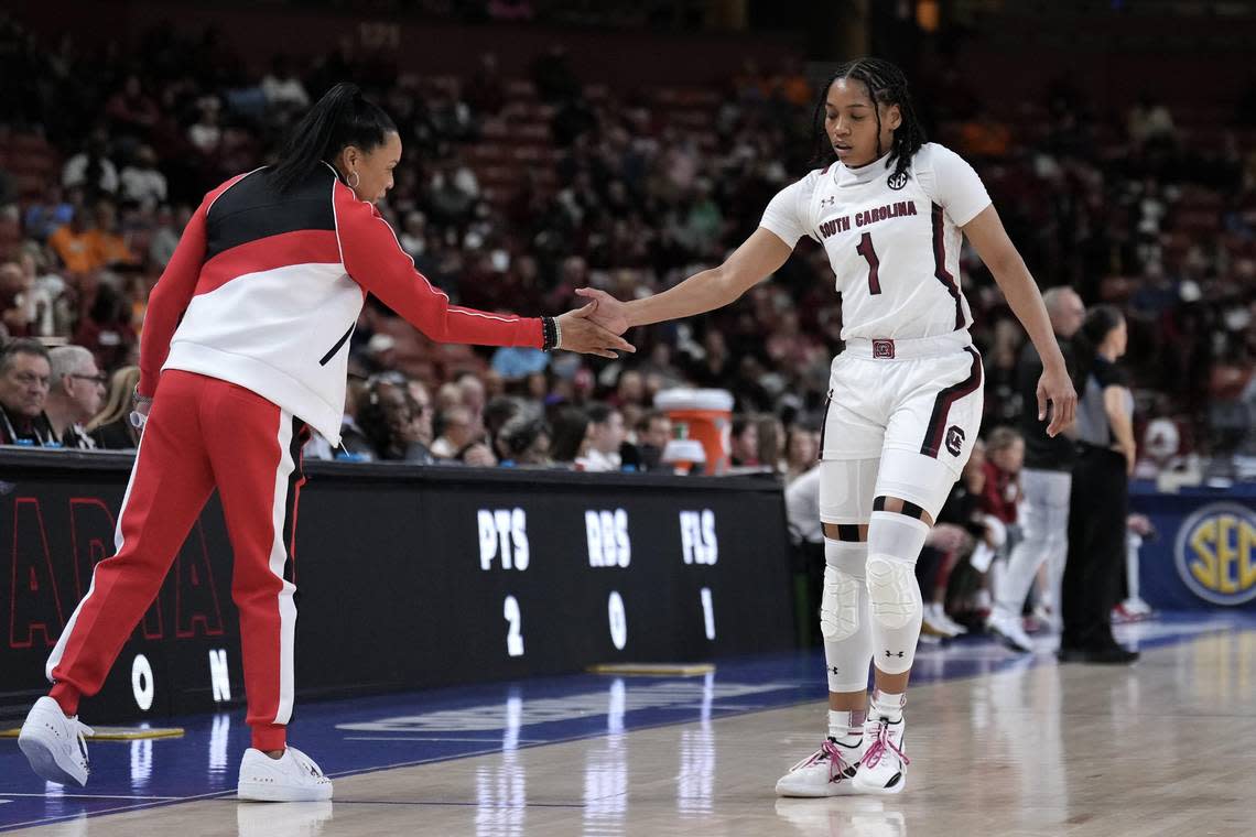 South Carolina Gamecocks head coach Dawn Staley gives a hand slap to guard Zia Cooke (1) in the first quarter at Bon Secours Wellness Arena.