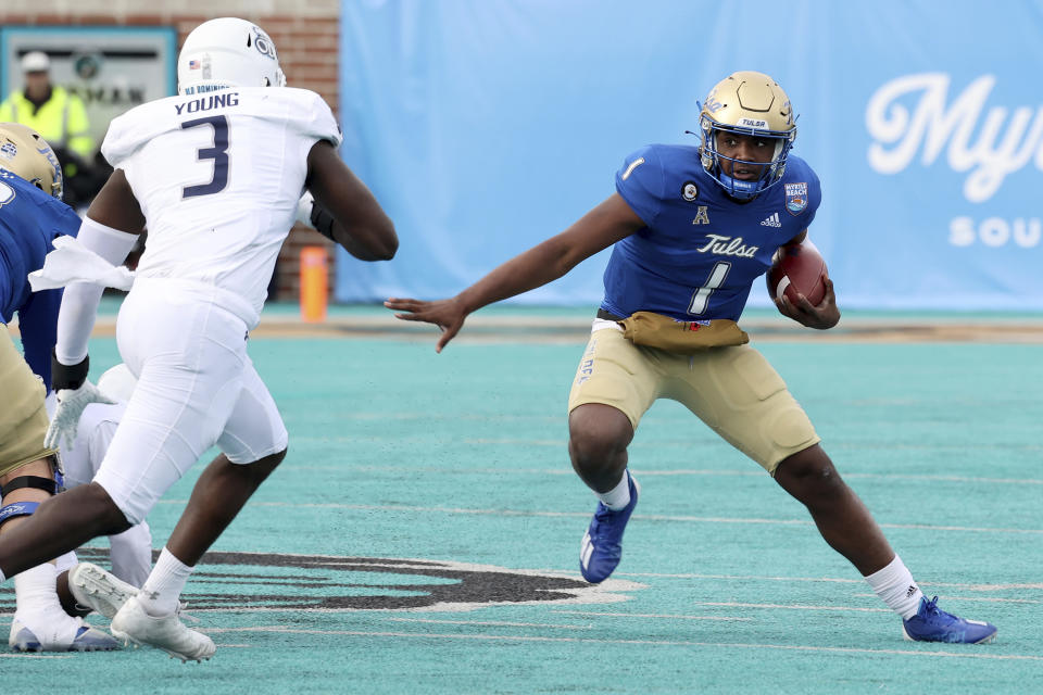 Tulsa's Braylon Braxton (1) runs around the defense of Old Dominion's Jordan Young (3) in the first half of an NCAA college football game in the Myrtle Beach Bowl in Conway, S.C., Monday, Dec. 20, 2021. (AP Photo/Mic Smith)