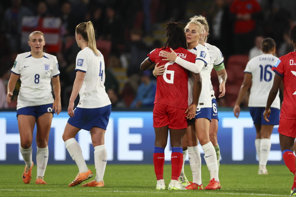 England's Alex Greenwood embraces Haiti's Melchie Dumonay after the Women's World Cup Group D soccer match between England and Haiti in Brisbane, Australia, Saturday, July 22, 2023. England won the match 1-0. (AP Photo/Tertius Pickard)