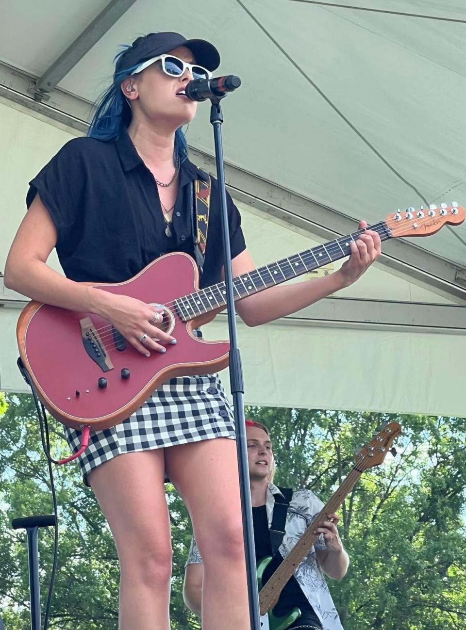 Jackie Popovec, lead singer for The Vindys, is shown performing at the Firestone Country Club earlier this month during the Bridgestone Senior Open Championship.