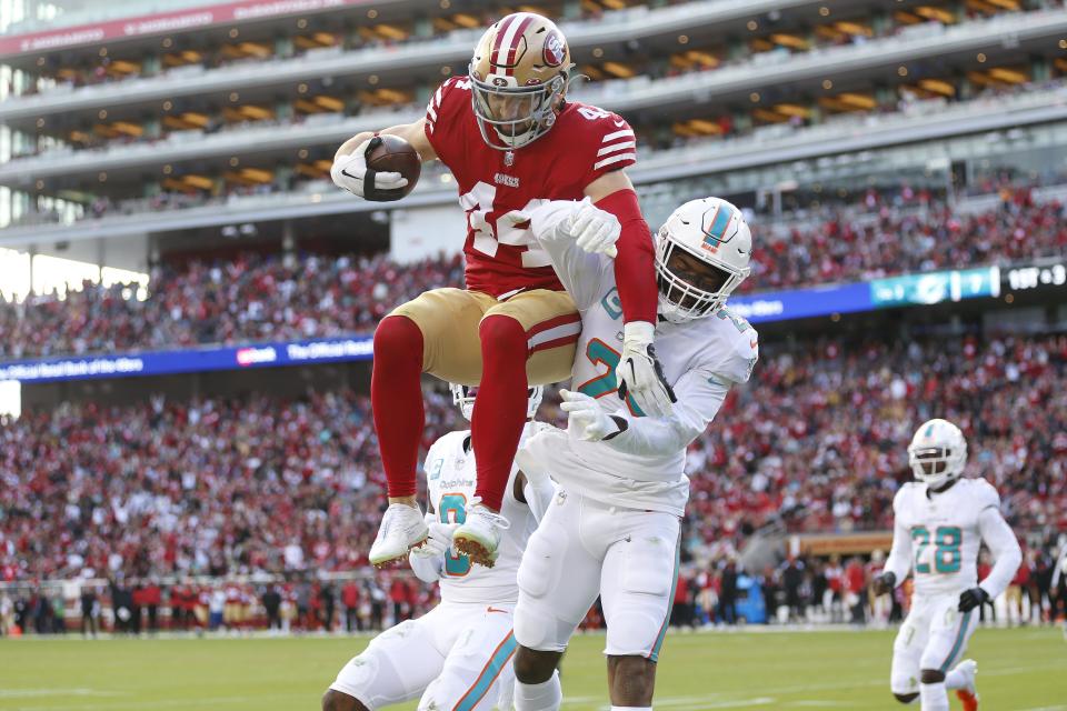 San Francisco 49ers fullback Kyle Juszczyk scores a first-half touchdown against Miami Dolphins cornerback Xavien Howard in Santa Clara, Calif., Sunday, Dec. 4, 2022.