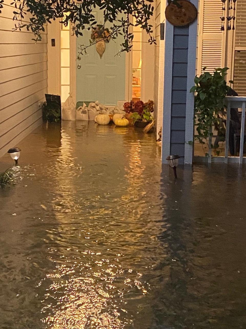 The front porch of Rebekah Ford's home in the Weatherly subdivision is flooded on Sunday night in Gainesville.