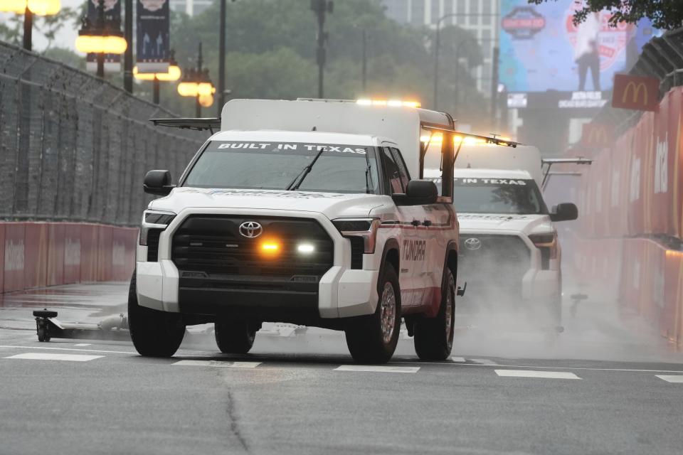 Crews dry the track before a NASCAR Cup Series auto race at the Grant Park 220 Sunday, July 2, 2023, in Chicago. (AP Photo/Morry Gash)