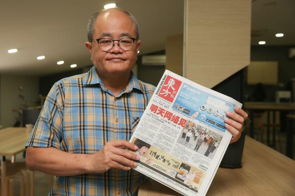 Editor-in-chief of Oriental Daily Ding Lee Leong holds up a copy of the final edition of the newspaper during an interview with Malay Mail in Petaling Jaya April 16, 2021. — Picture by Choo Choy May