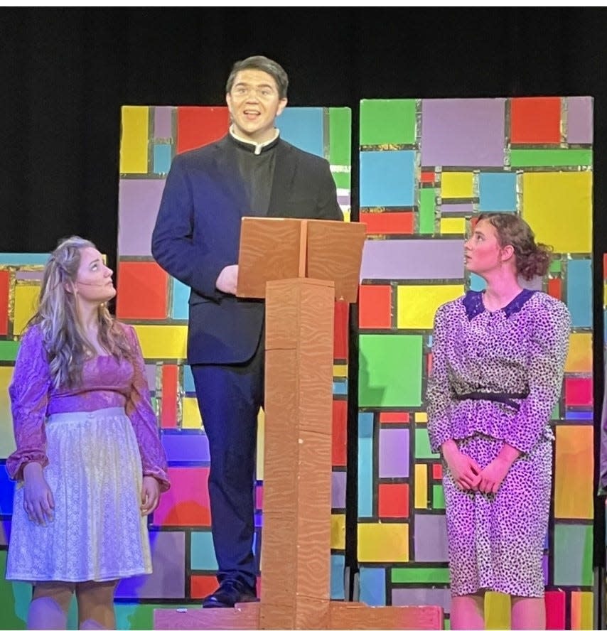 Colin Rubsamen, as Rev. Shaw Moore, delivers a sermon while Mackenzie Ennis, left, as his daughter, Ariel, and Clara Brine, as his wife, Vi, listen in Pleasantville High School's production of "Footloose," which runs March 8, 9, 10, 15 and 16.