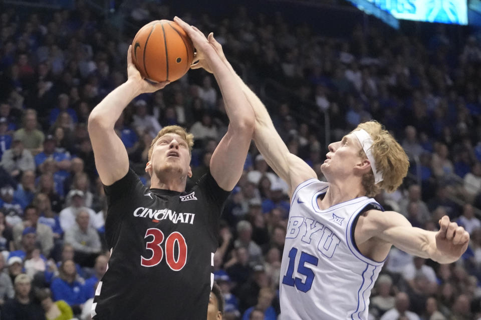 BYU guard Richie Saunders (15) defends against Cincinnati forward Viktor Lakhin (30) during the first half of an NCAA college basketball game Saturday, Jan. 6, 2024, in Provo, Utah. (AP Photo/Rick Bowmer)