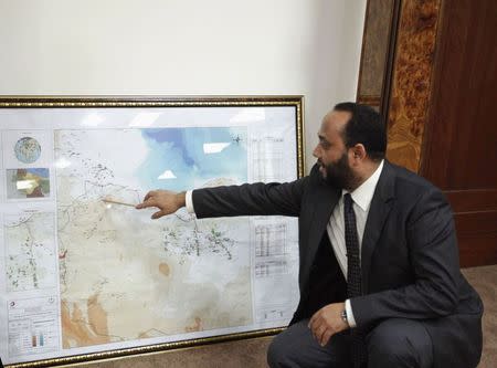 Mashallah Zwai, Oil Minister in rival Prime Minister Omar al-Hassi's government, points at a map during an interview with Reuters in Tripoli November 25, 2014. REUTERS/Ismail Zitouny