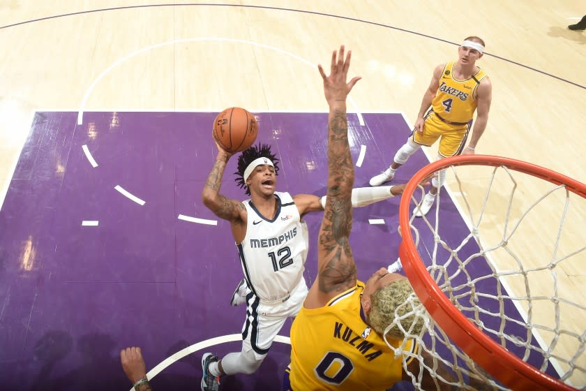 Lakers forward Kyle Kuzma tries to block the shot of Memphis Grizzlies rookie Ja Morant on Feb. 21 at Staples Center.