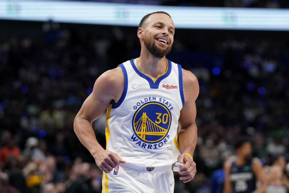 Golden State Warriors guard Stephen Curry (30) reacts after making a 3-point basket during the first half against the Dallas Mavericks in Game 3 of the NBA basketball playoffs Western Conference finals, Sunday, May 22, 2022, in Dallas. (AP Photo/Tony Gutierrez)