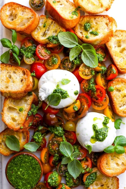 <p>Two Peas and Their Pod</p><p>Serve burrata with tomatoes, basil pesto, and garlic toasts at your next summer party! This simple summer appetizer is always a crowd pleaser!</p><p><strong>Get the recipe: <a href="https://www.twopeasandtheirpod.com/burrata-with-tomatoes-pesto/" rel="nofollow noopener" target="_blank" data-ylk="slk:Burrata with Tomatoes and Pesto;elm:context_link;itc:0;sec:content-canvas" class="link rapid-noclick-resp"><em>Burrata with Tomatoes and Pesto</em></a></strong></p>