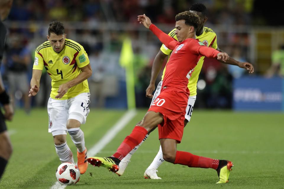 <p>Dele Alli tries to stop Colombia’s Santiago Arias from breaking down the touchline </p>