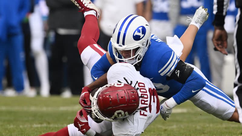 Brigham Young Cougars safety Crew Wakley (38) brings down Oklahoma Sooners wide receiver Jalil Farooq (3) as BYU and Oklahoma play at LaVell Edwards Stadium in Provo on Saturday, Nov. 18, 2023.