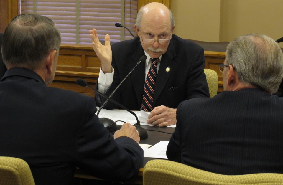 Kansas state Sen. Les Donovan, a Wichita Republican, makes a point during negotiations over tax policy with Reps. Richard Carlson, left, a St. Marys Republican, and Marvin Kleeb, right, an Overland Park Republican, Monday April 30, 2012, at the Statehouse in Topeka, Kan. (AP Photo/John Hanna)