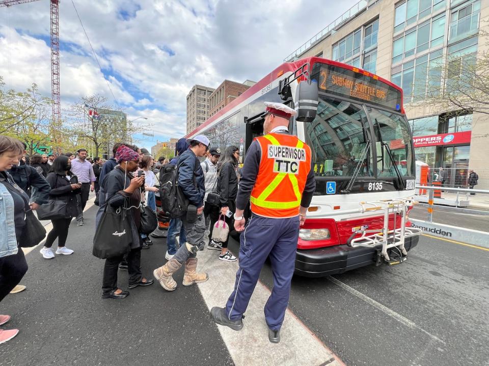 Commuters board a TTC shuttle bus on May 13, 2024.