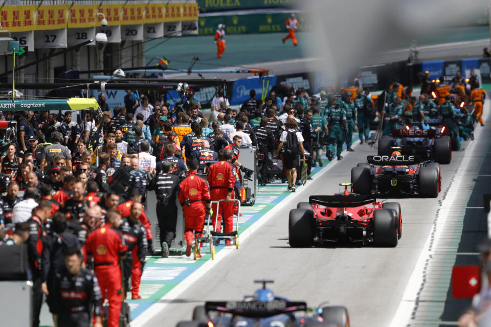 Drivers line up at pit lane after an aborted start due to collisions during the Brazilian Formula One Grand Prix at the Interlagos race track in Sao Paulo, Brazil, Sunday, Nov. 5, 2023. (AP Photo/Marcelo Chello, Pool)