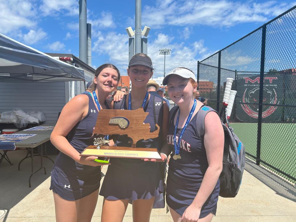 Pembroke High girls tennis singles players Ruth Dannison (left), Nicole Makarewicz (center) and Emma Gerlach (right) pose with the MIAA Division 3 state championship trophy after beating Weston, 3-2, at MIT's courts on Saturday, June 15, 2024.