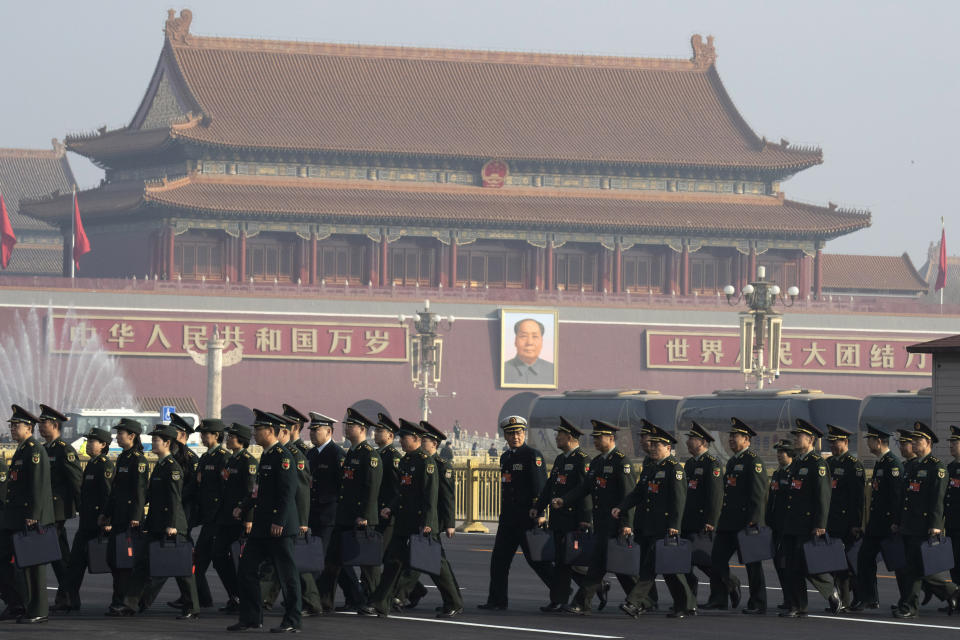 Chinese military delegates arrive for a meeting on the eve of the opening session of the National People's Congress held at the Great Hall of the People in Beijing, China, Monday, March 4, 2019. A year since removing any legal barrier to remaining China's leader for life, Xi Jinping appears firmly in charge, despite a slowing economy, an ongoing trade war with the U.S. and rumbles of discontent over his concentration of power. (AP Photo/Ng Han Guan)