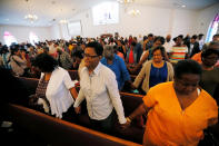 <p>Members of Charlottesville’s Mt. Zion First African Baptist Church pray during Sunday services the morning after the attack on counter-protesters at the “Unite the Right” rally organized by white nationalists in Charlottesville, Virginia, U.S., August 13, 2017. (Jim Bourg/Reuters) </p>