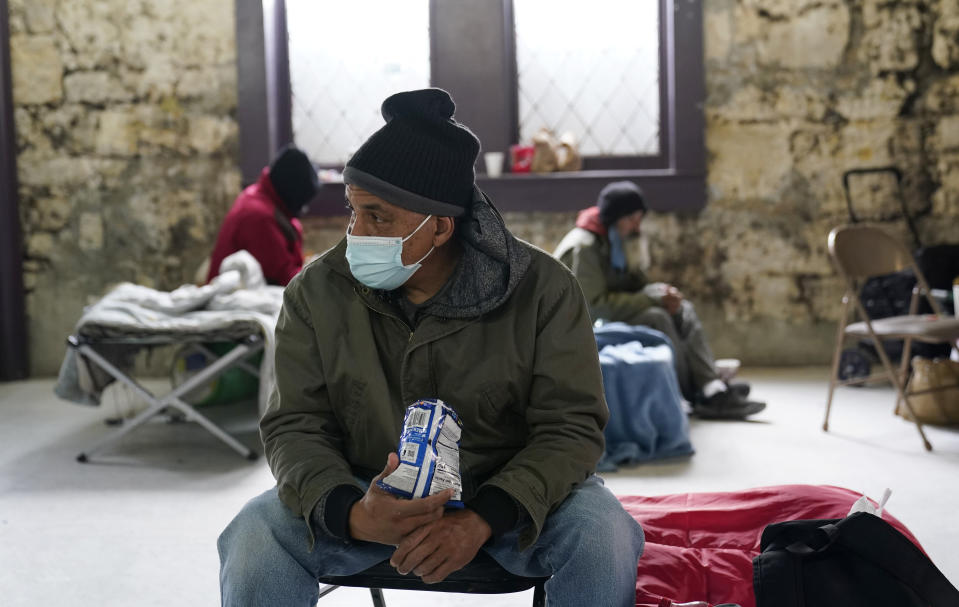 People seeking shelter from sup-freezing temperatures gather at a make-shift warming shelter at Travis Park Methodist Church, Tuesday, Feb. 16, 2021, in San Antonio. (AP Photo/Eric Gay)