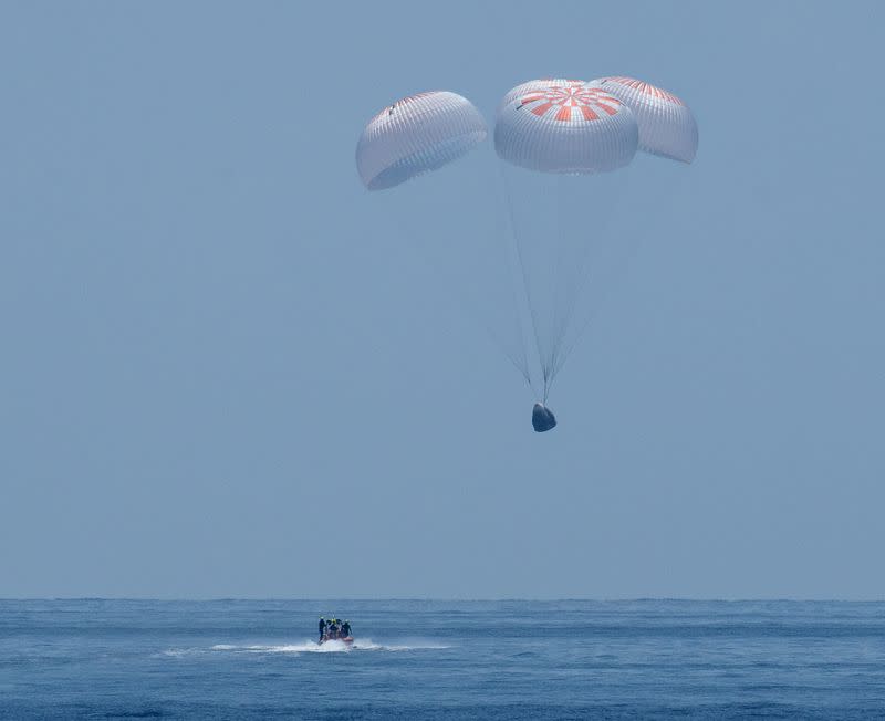 The SpaceX Crew Dragon Endeavour spacecraft is seen as it lands with NASA astronauts Robert Behnken and Douglas Hurley onboard in the Gulf of Mexico off the coast of Pensacola, Florida