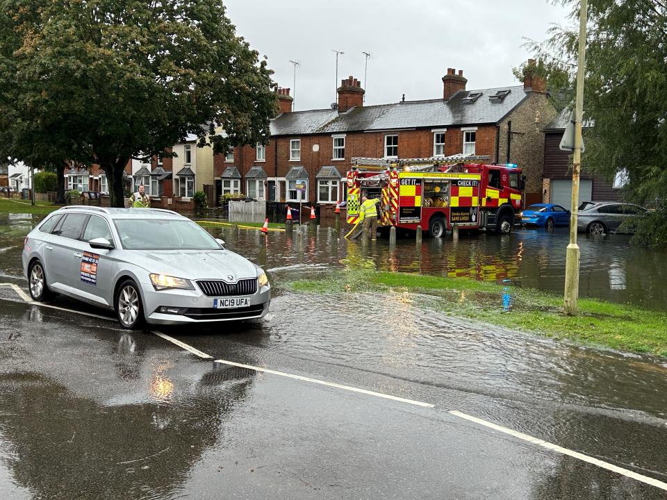 Firefighters pumping water out of homes on Woolgrove Road along the River Purwell in Hitchin (Wesley Johnson/PA Wire)