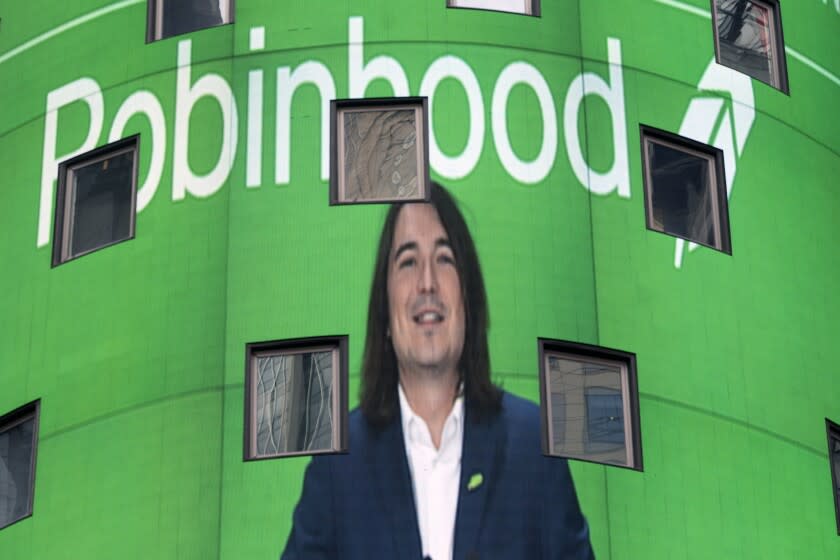 FILE - Vladimir Tenev, CEO and co-founder of Robinhood, is shown on an electronic screen at Nasdaq in New York&#39;s Times Square following his company&#39;s IPO, Thursday, July 29, 2021. Robinhood&#39;s stock is flying again Wednesday, Aug. 4, jumping so much that trading was temporarily halted three times in the first half hour after the market opened. (AP Photo/Mark Lennihan, File)