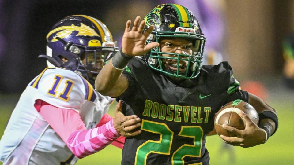 Roosevelt’s Dimareea Banks, right, weaves his way past Fresno High defenders during the annual Little Big Game at Sunnyside High School Stadium on Friday, Oct. 27, 2023.